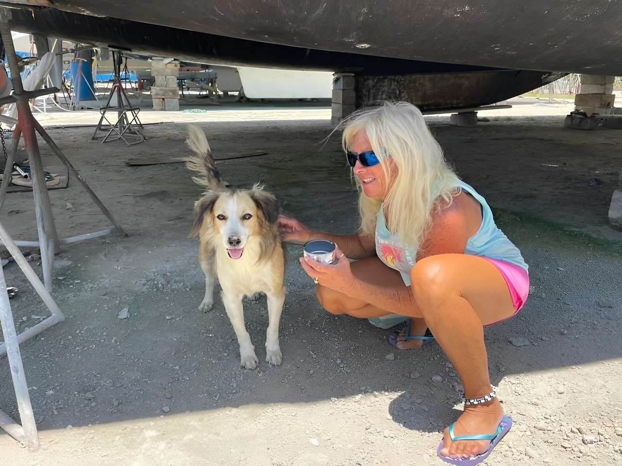 Captain Cheryl feeding Fluffy, yard dog | Carriacou, Grenada