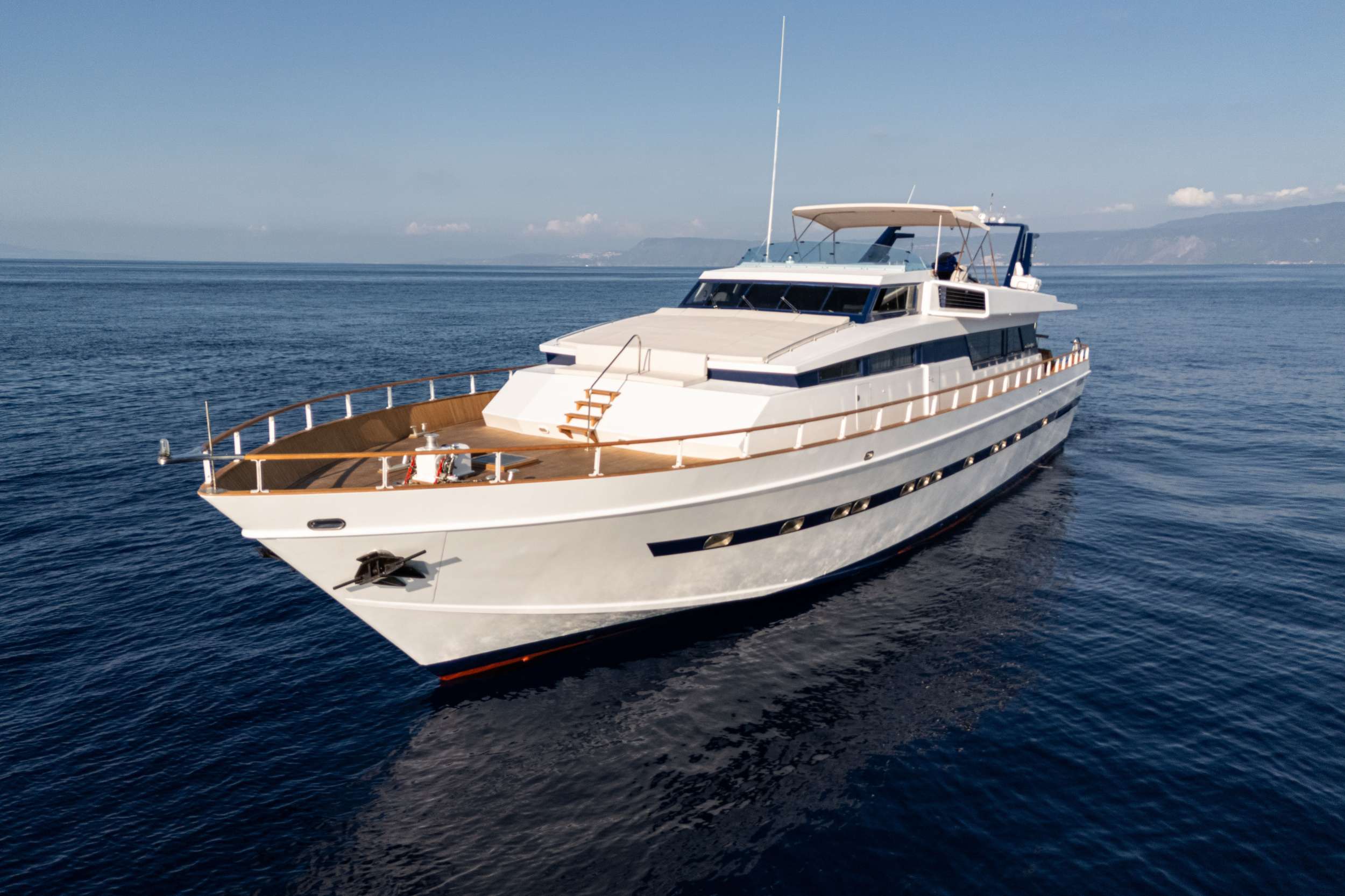 Constructed in 1977 by the Cantieri di Pisa shipyard, Olga, drawn by Designer Pierluigi Spadolini, features a design that has influenced luxury yacht construction for years to come after her construction.
The layout focus is on a compact, streamlined superstructure, with glazed openings and dark portholes emphasizing the habitability.
The interior spaces offer comfort and luxury, with a spacious living area, an indoor dining room, a fully equipped galley and well-appointed cabins.

Olga is available for charter starting from 2024, after the first year of an undergoing two-years refit that will conclude in 2025.
The elegant salon features 2 sofas, a coffee table, and a round card table.
The aft deck offers a spacious dining table for up to 10 guests, while the foredeck is perfect for sunbathing. The sundeck includes an alfresco dining area and space for sunbathing.

Renovated in 2024:
Interior & exterior furniture
Interior & exterior upholstery
Cabin bathrooms
Interior decor
Mattresses and pillows
Lighting renovation
Starlink wi-fi connection
Smart Tv in the saloon and cabins
New water toys added